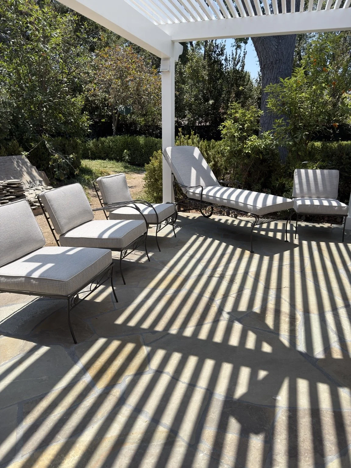 Finished outdoor seating with fitted neutral cushions beneath a Pasadena pergola