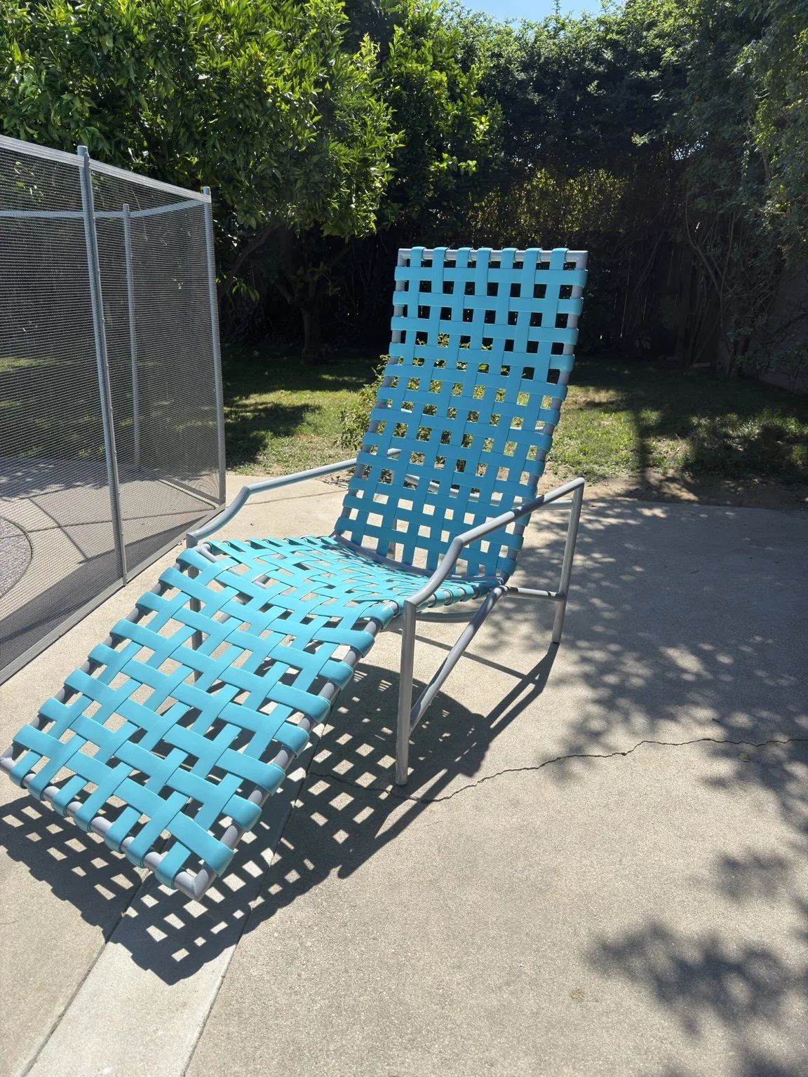 Chaise lounge with bright blue woven vinyl straps