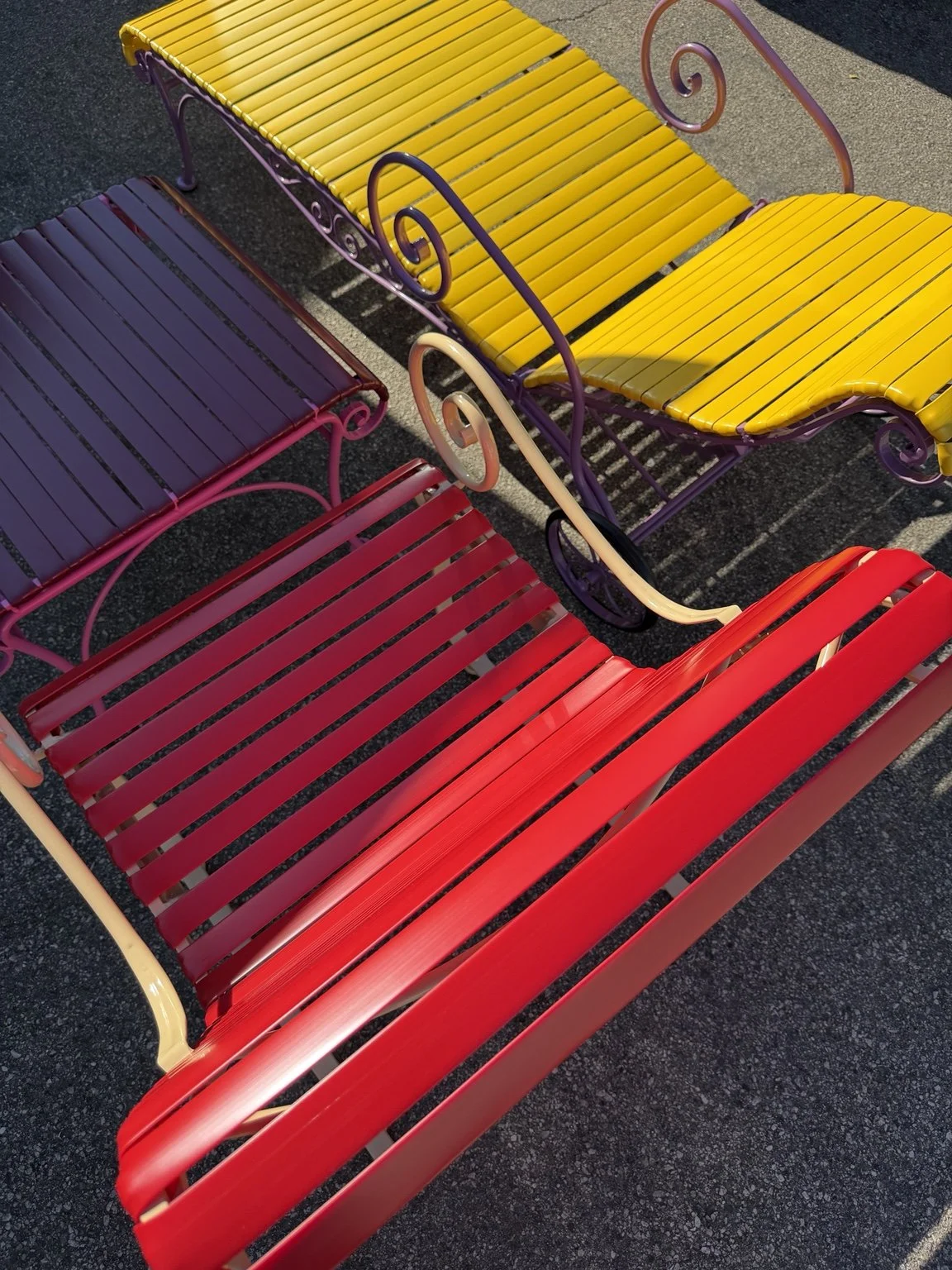 Red and yellow horizontal vinyl straps on ornate chaise lounges