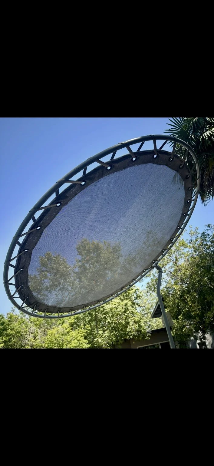 Dark round shade canopy and frame before restoration at a Pasadena property