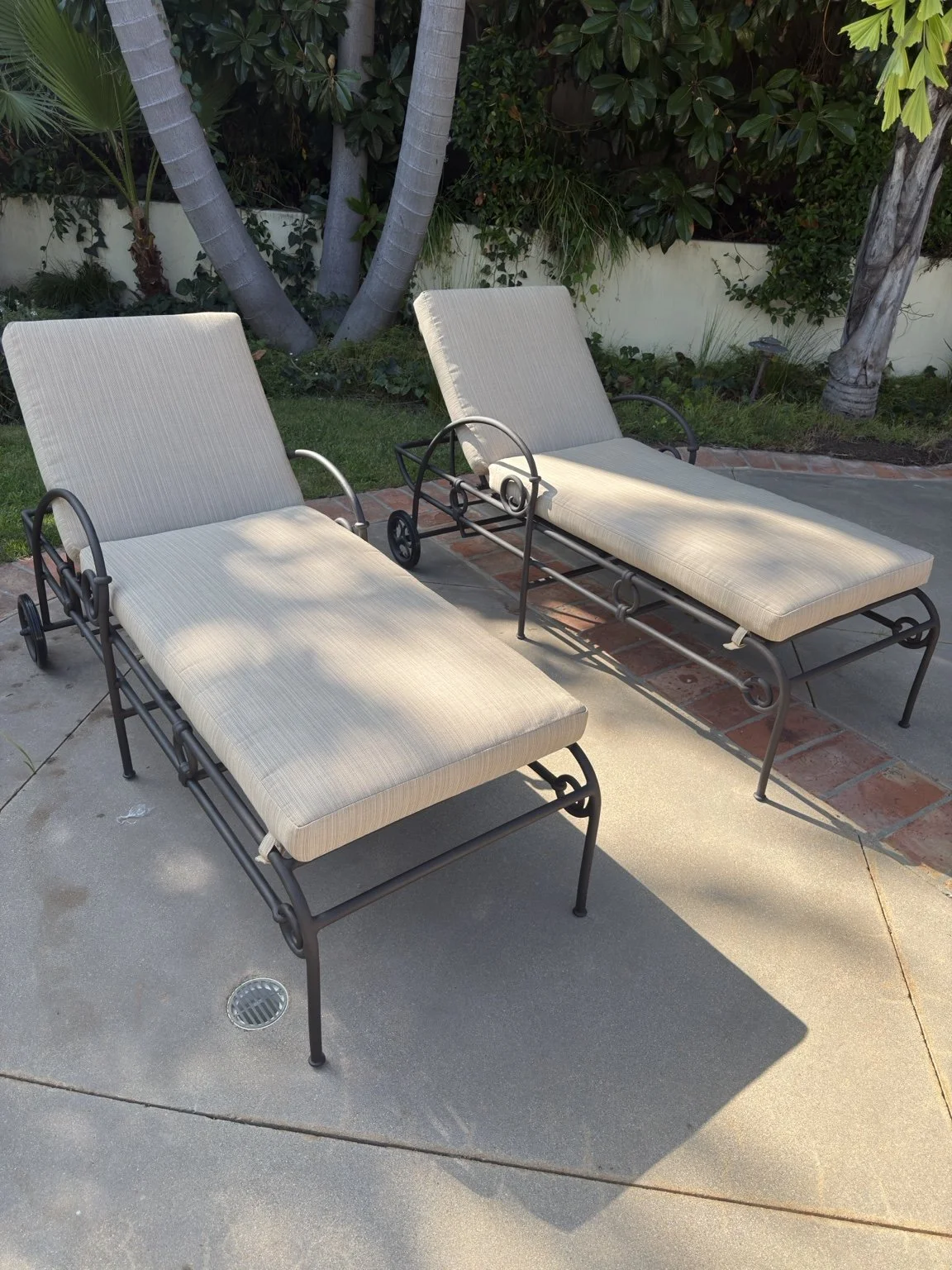 Custom pale chaise lounge cushions viewed from the garden side of an outdoor patio
