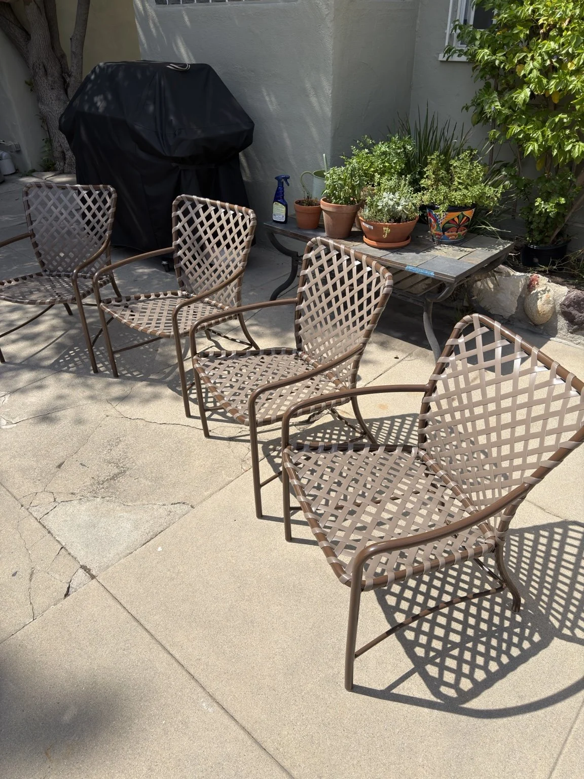 Brown patio dining chairs fitted with woven cross straps