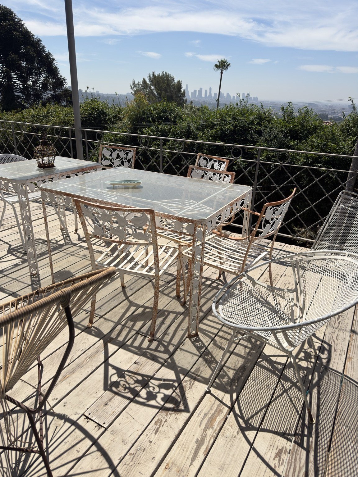 Before restoration: white metal patio dining furniture with rust and a worn finish