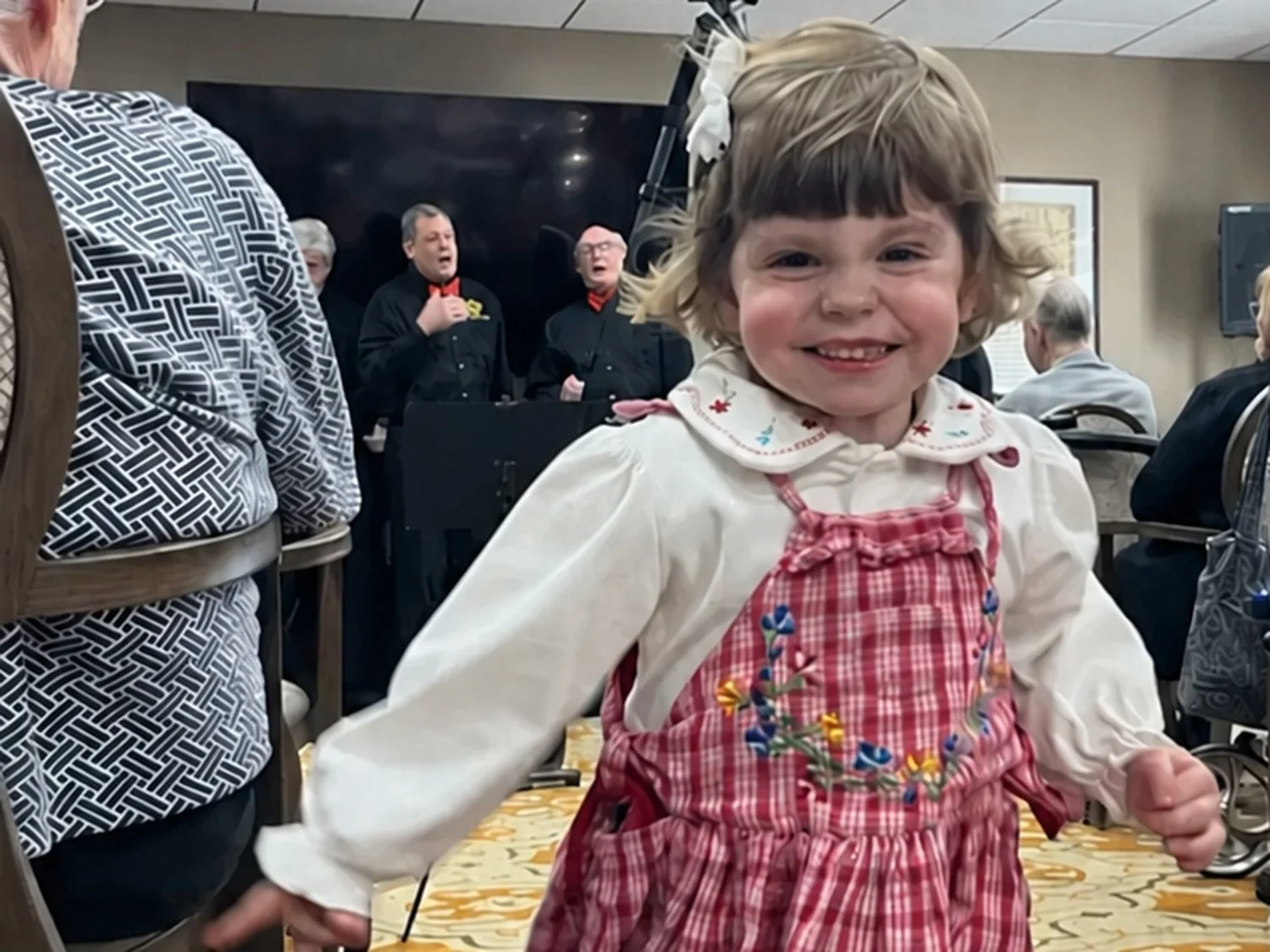 Girl dancing joyfully at a Service to Seniors party