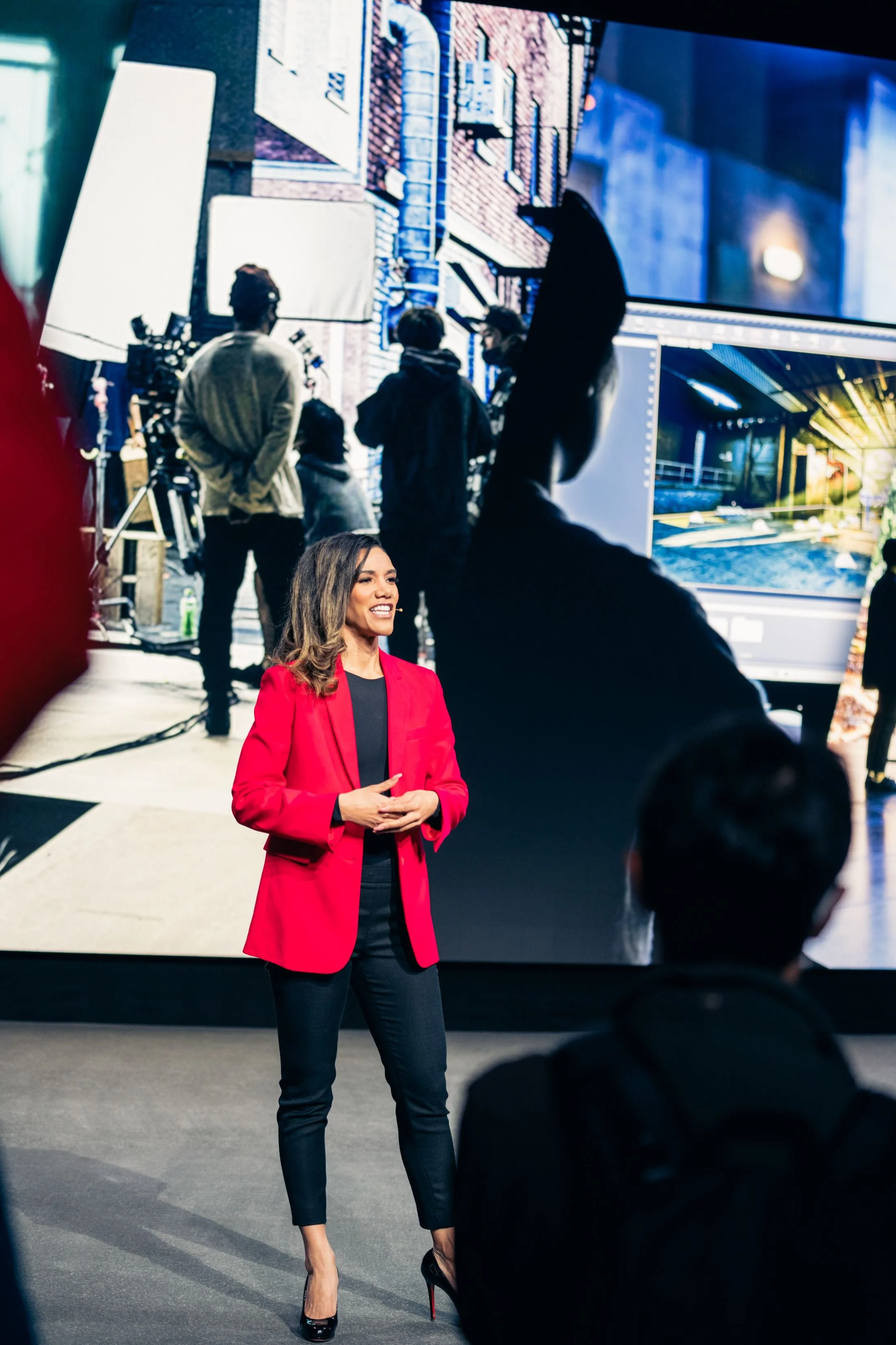 Dionna Chambers in a red blazer presenting on stage for Sony