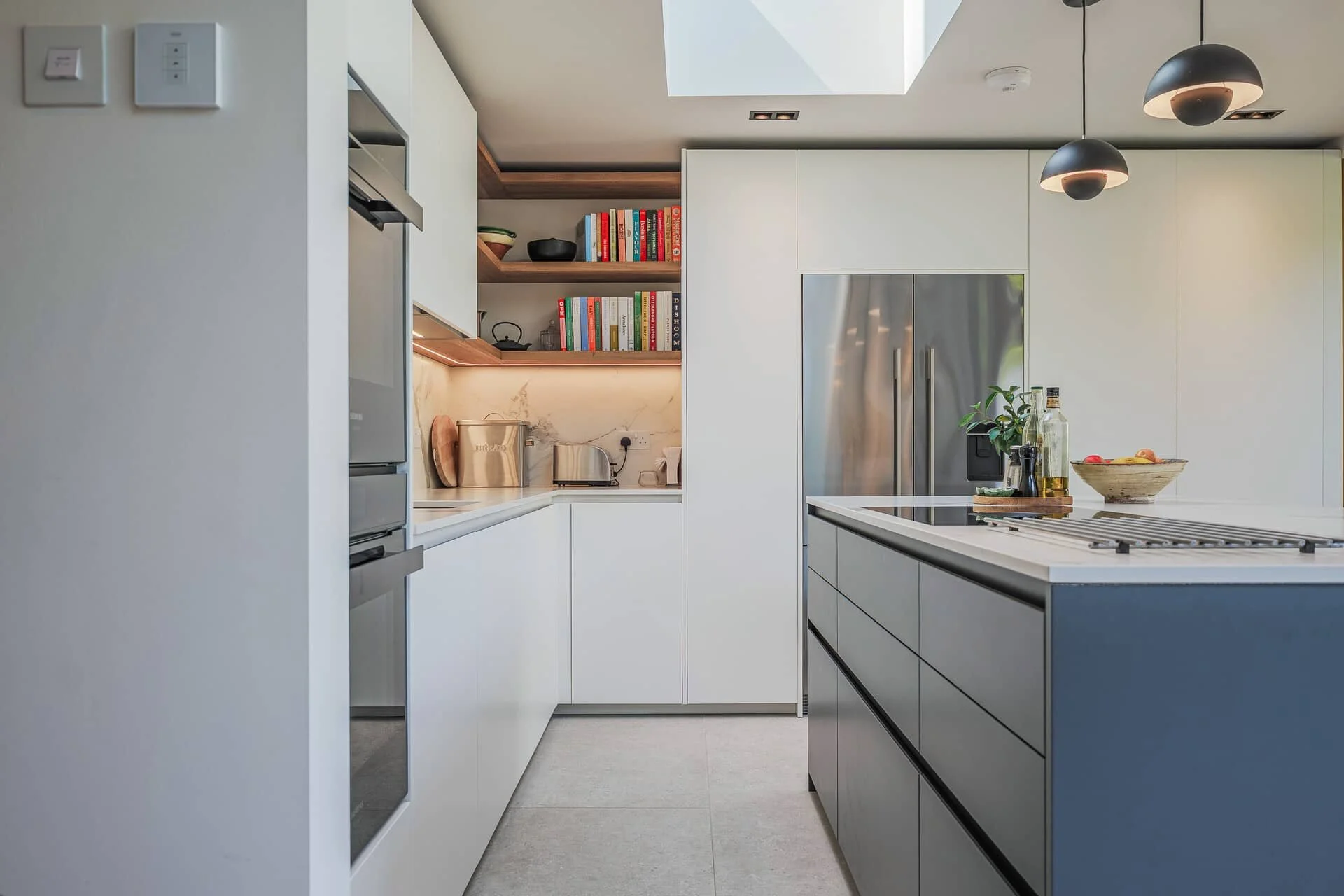 Kitchen with appliances and storage concealed in the cabinetry.