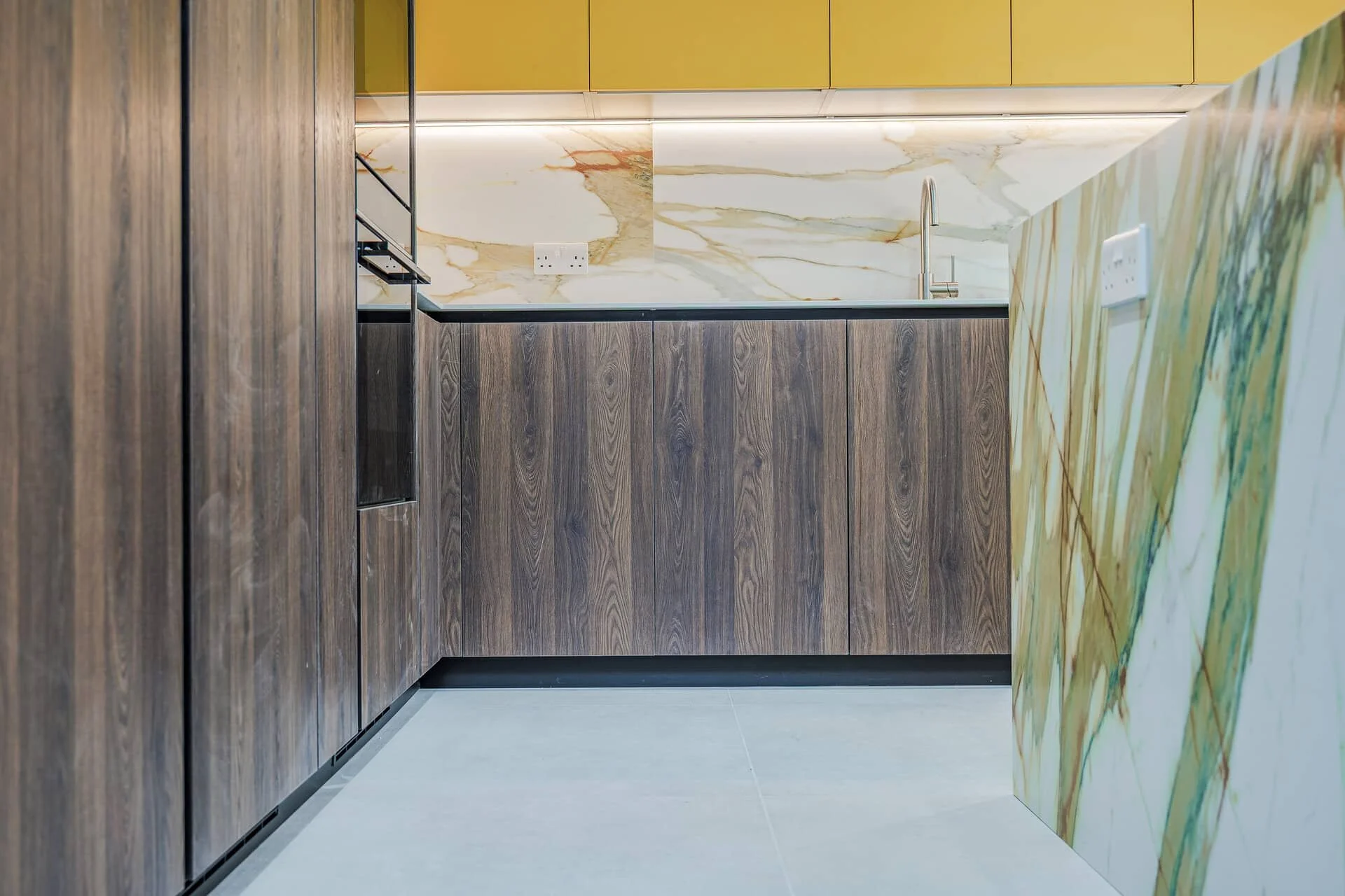 Handleless kitchen cabinetry with flat-fronted doors and integrated handles.