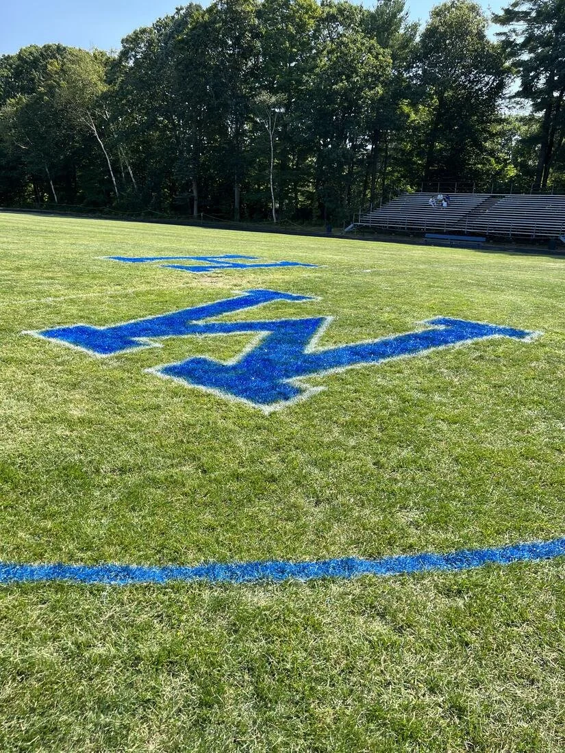 Elmscape crew lining an athletic field