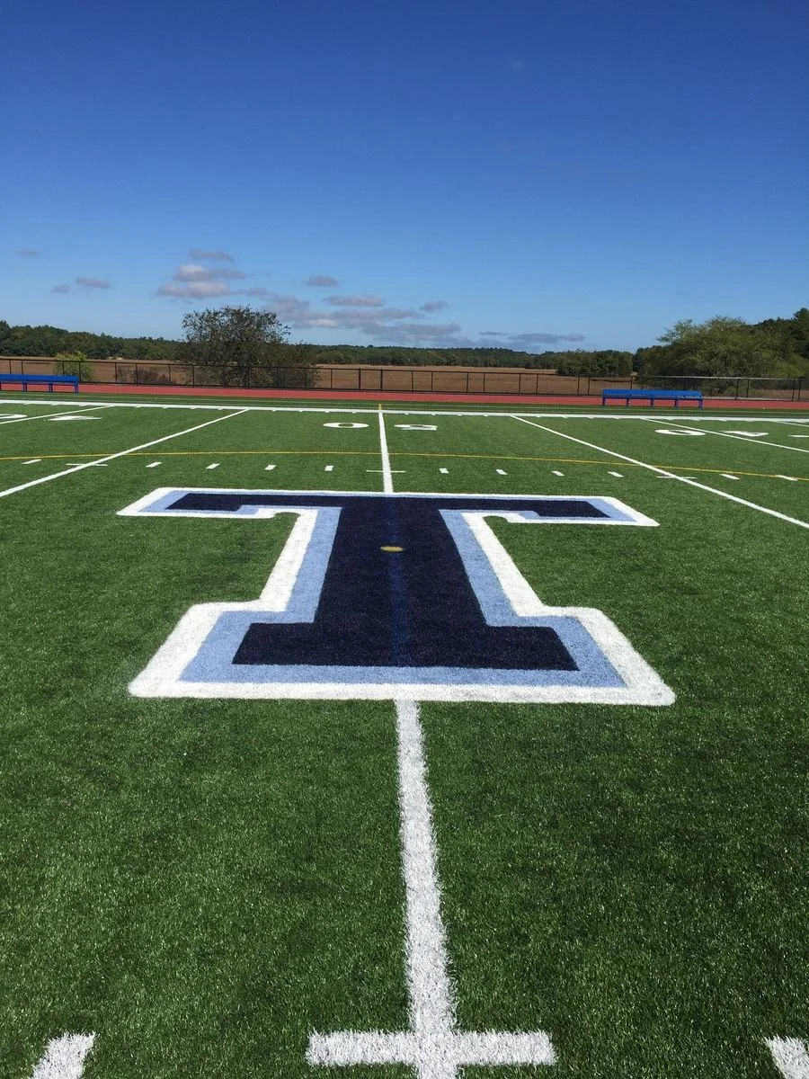 Custom school logo painted at midfield
