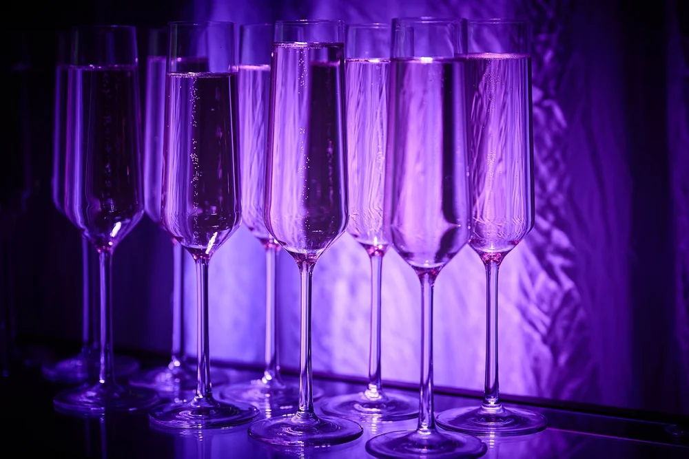 A wall of champagne glasses guests collect on arrival at the Change Make*Hers Gala