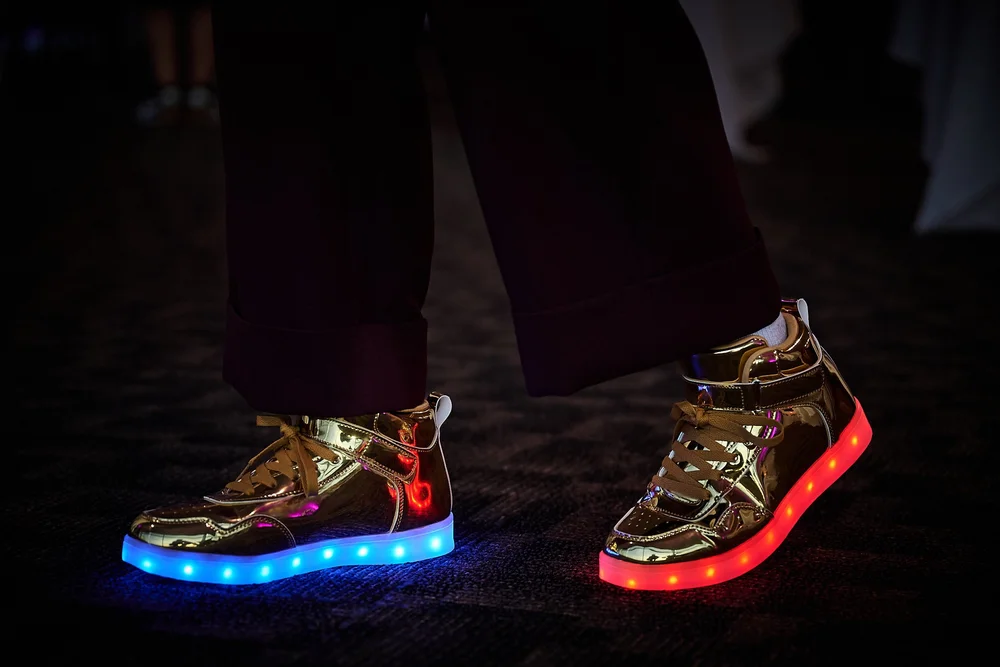A guest showing the branded shoes given out at the Change Make*Hers Gala