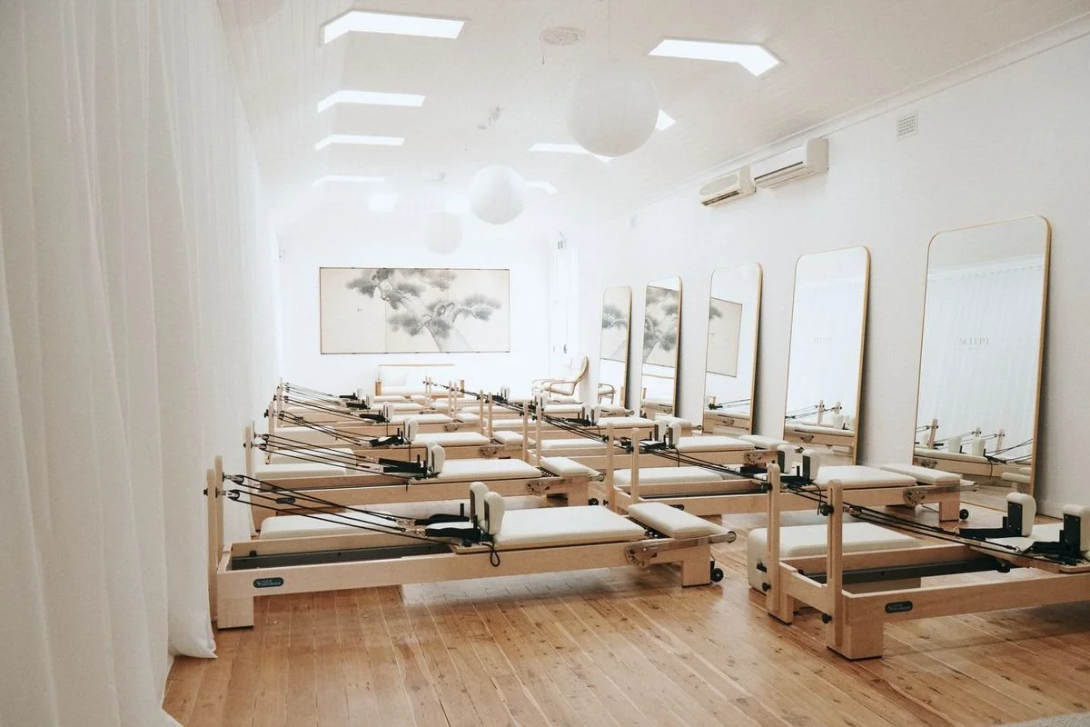 The Sculpt studio: twelve reformers, sheer curtains and a mirror wall