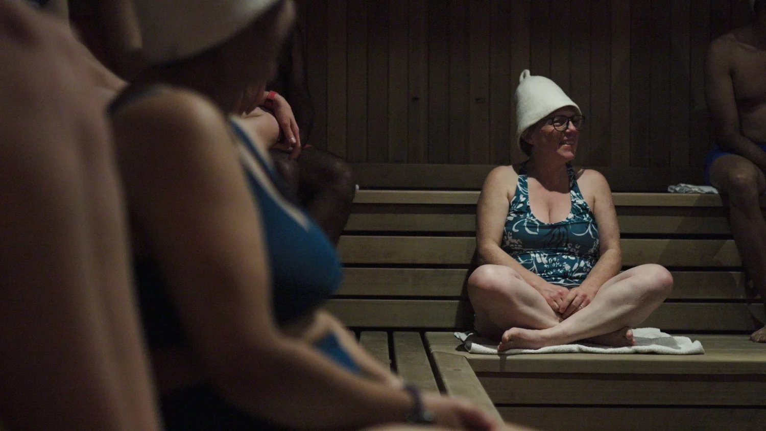 A smiling participant in the sauna at the London Recalibrate & Restore day