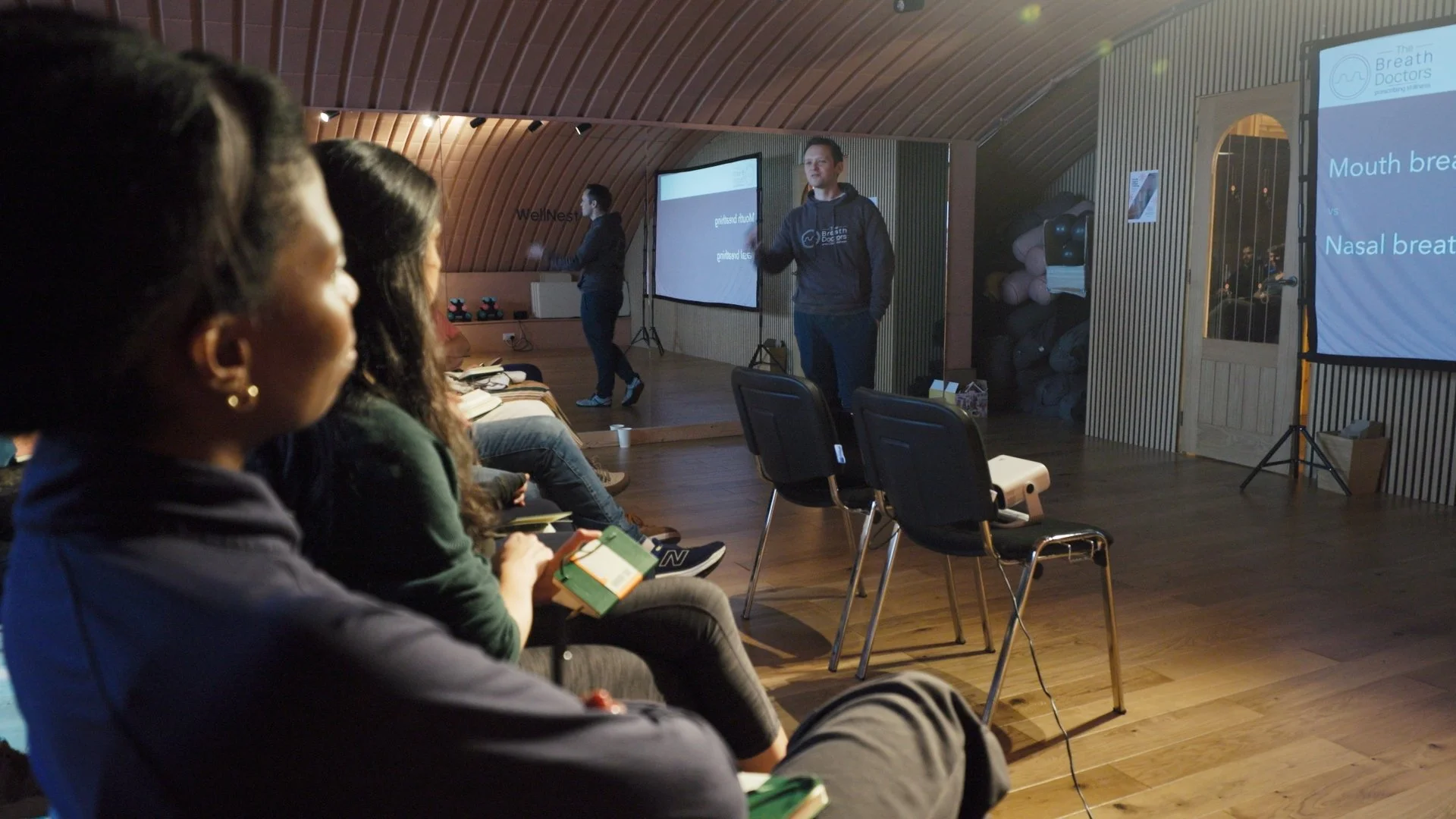 Doctor-led teaching with slides and seated delegates at the London Recalibrate & Restore day