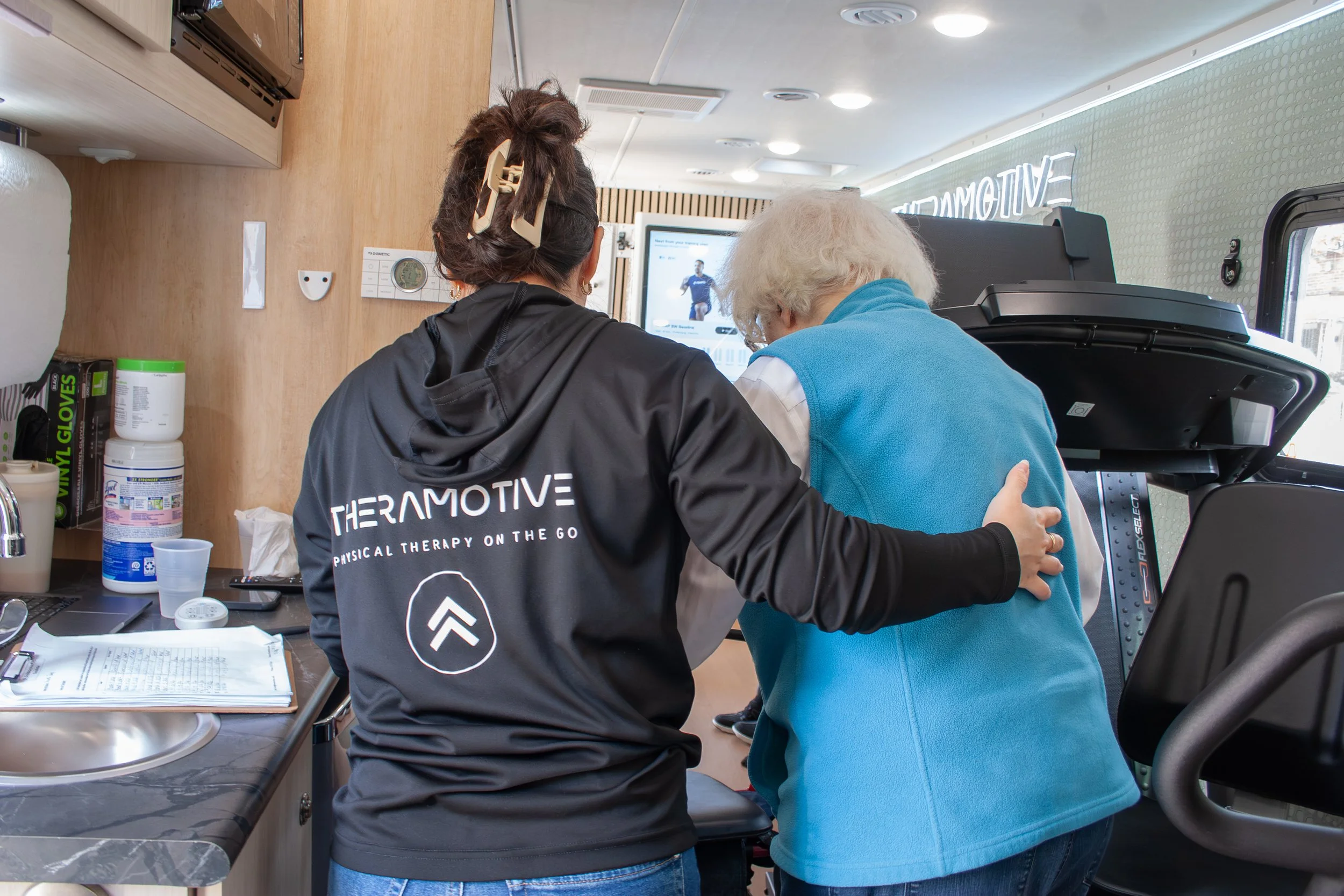 TheraMotive clinician assisting an older adult