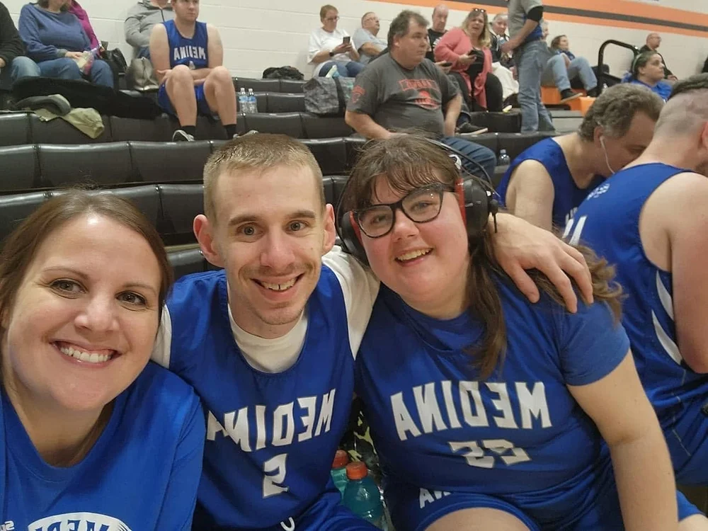 Three Flash teammates smiling together in Medina jerseys.