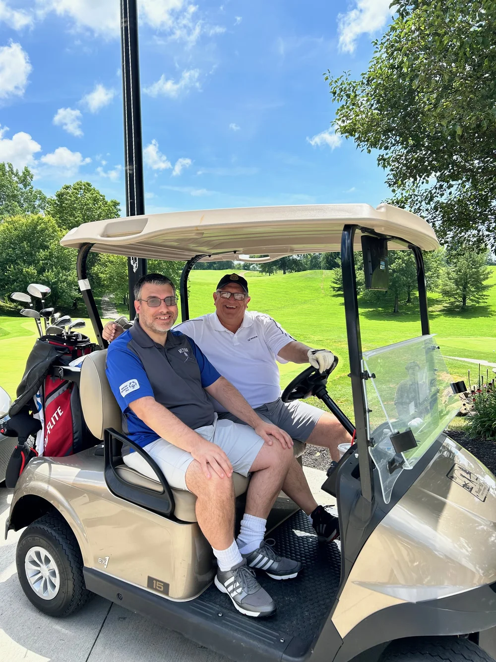 Flash athletes riding a golf cart on the course.