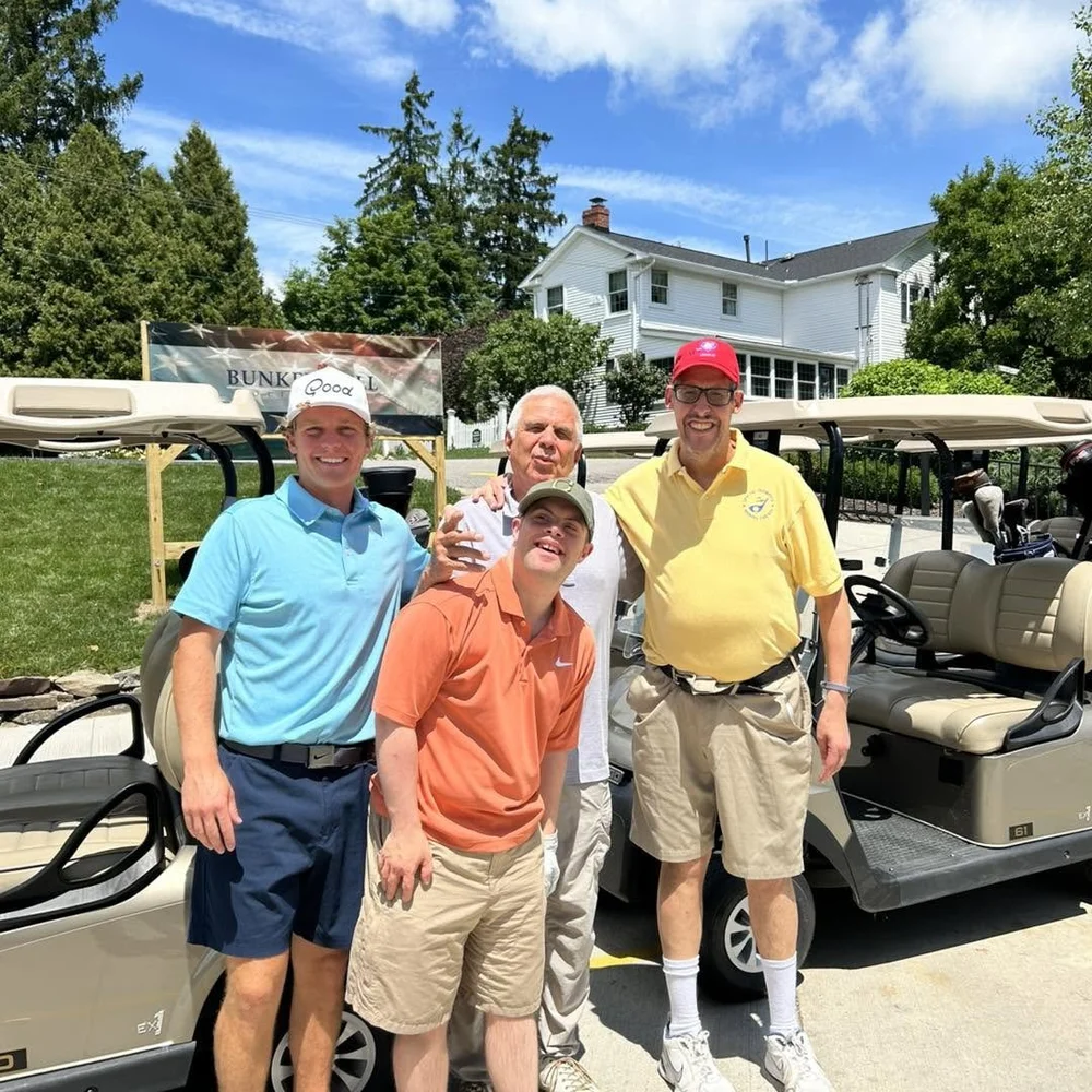 Flash golfers and friends with their carts on the course.