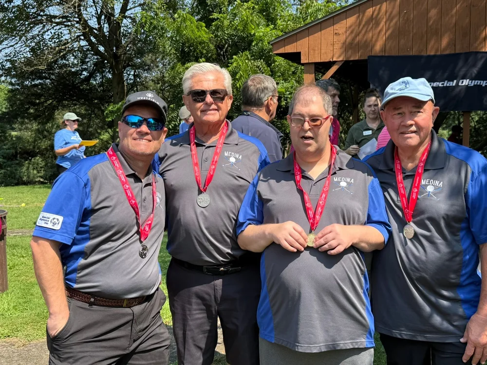 Flash golfers with their medals after a round.
