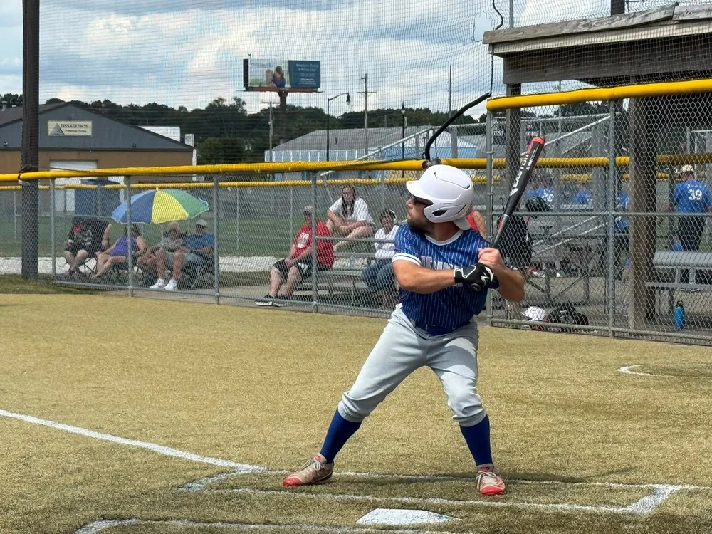 A Flash athlete at bat during a softball game.
