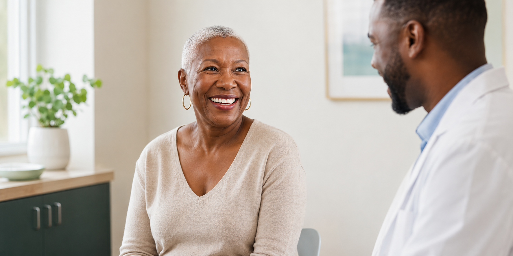 An older Black woman speaking with her physician during a clinical consultation