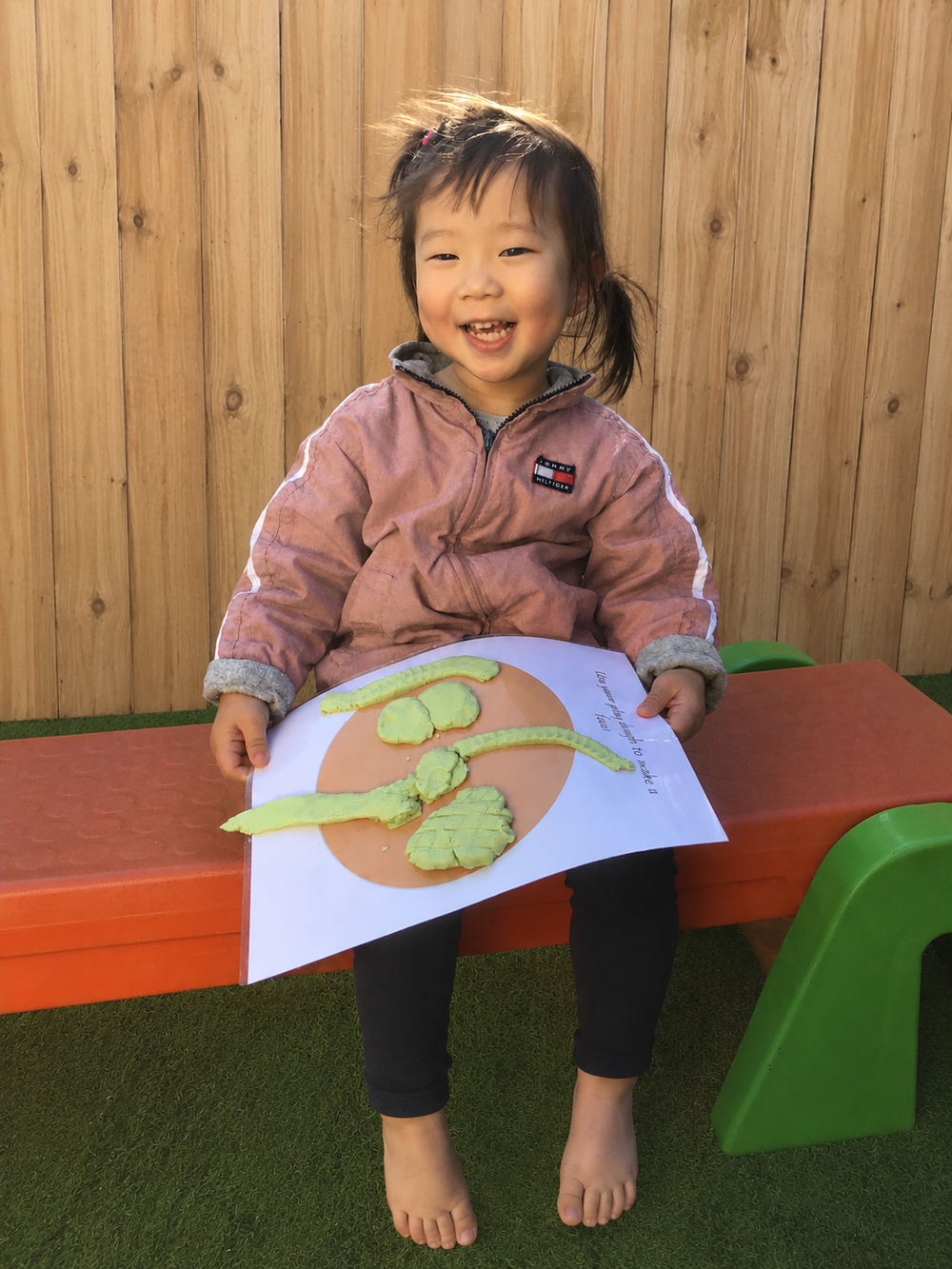 Toddler proudly showing her learning experience.