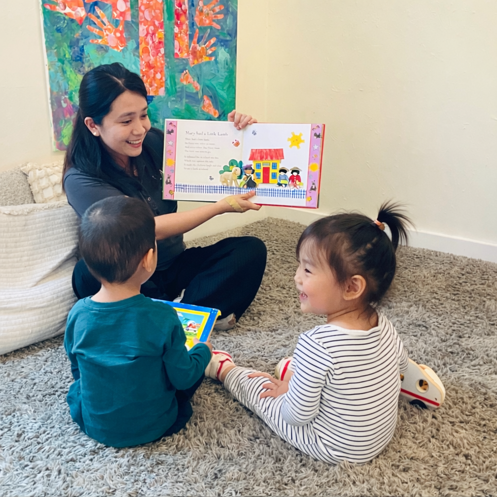 Kelvin Kindergarten educator sharing a happy learning experience with young children