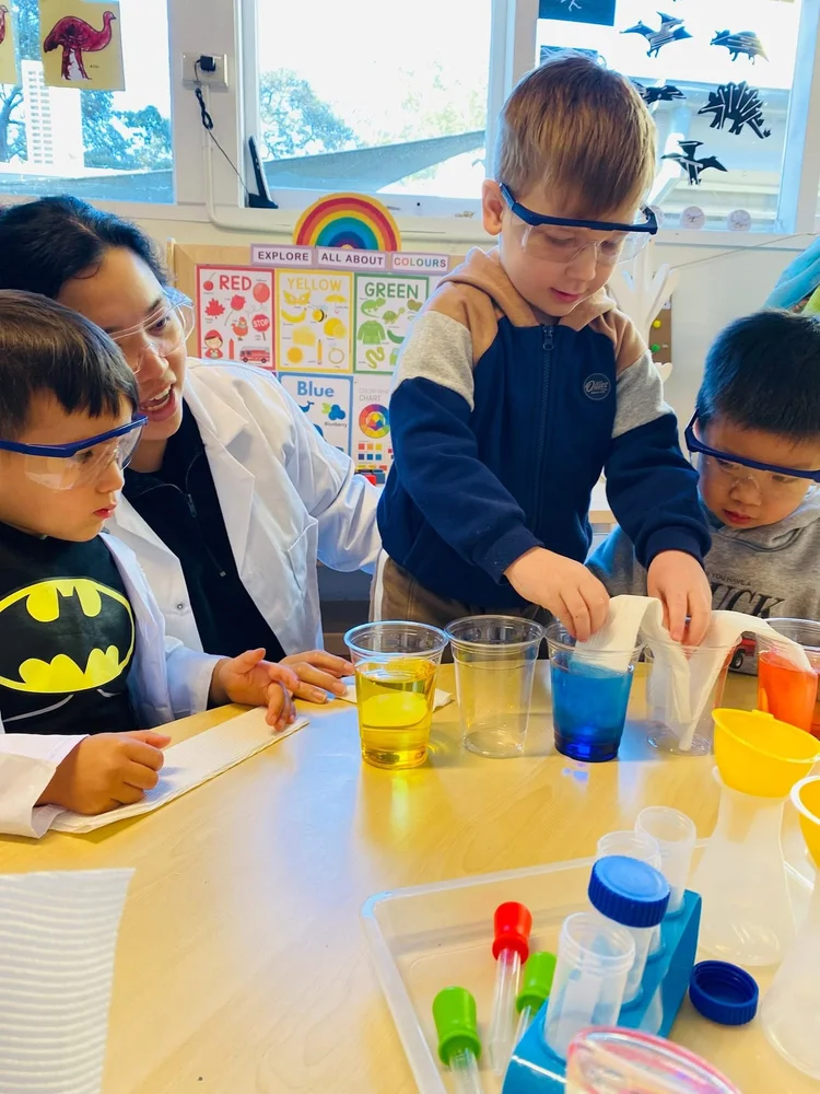Children and an educator exploring a colour science experiment