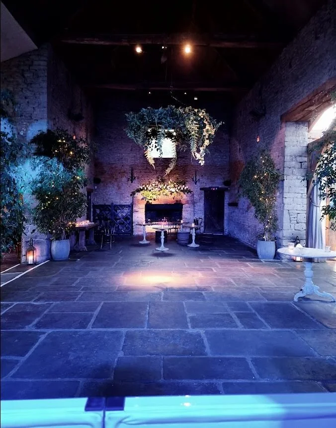Cripps Barn wedding dance floor with blue and purple lighting before guests arrive