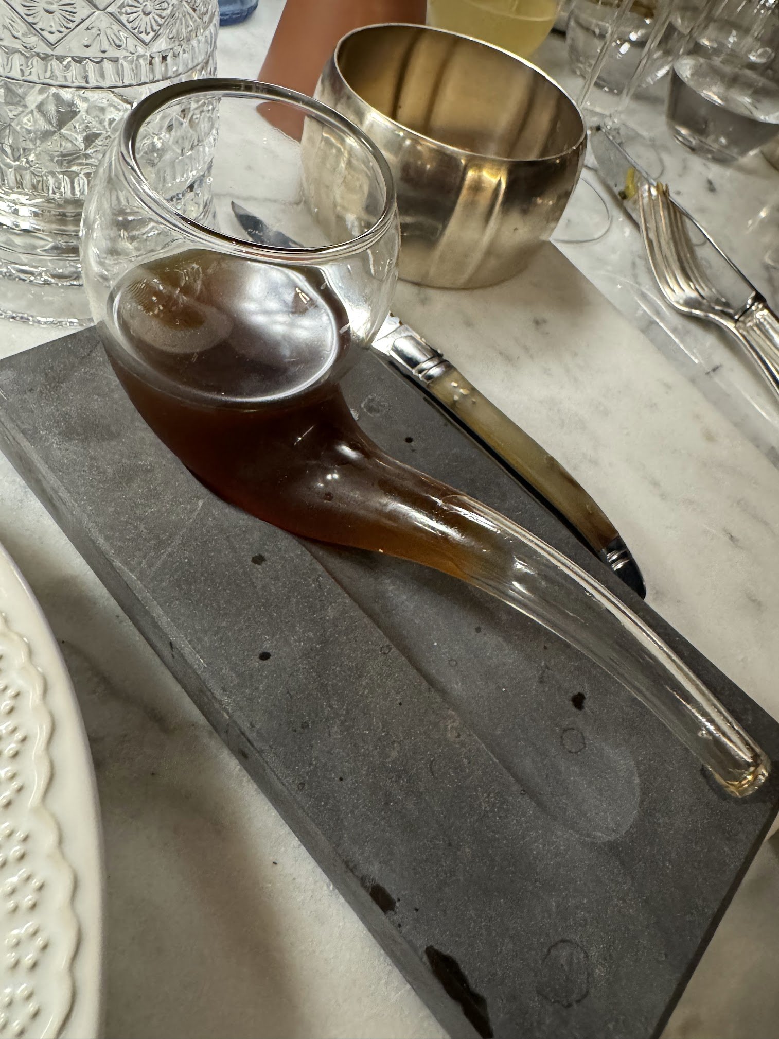 A whiskey cocktail served in a glass pipe