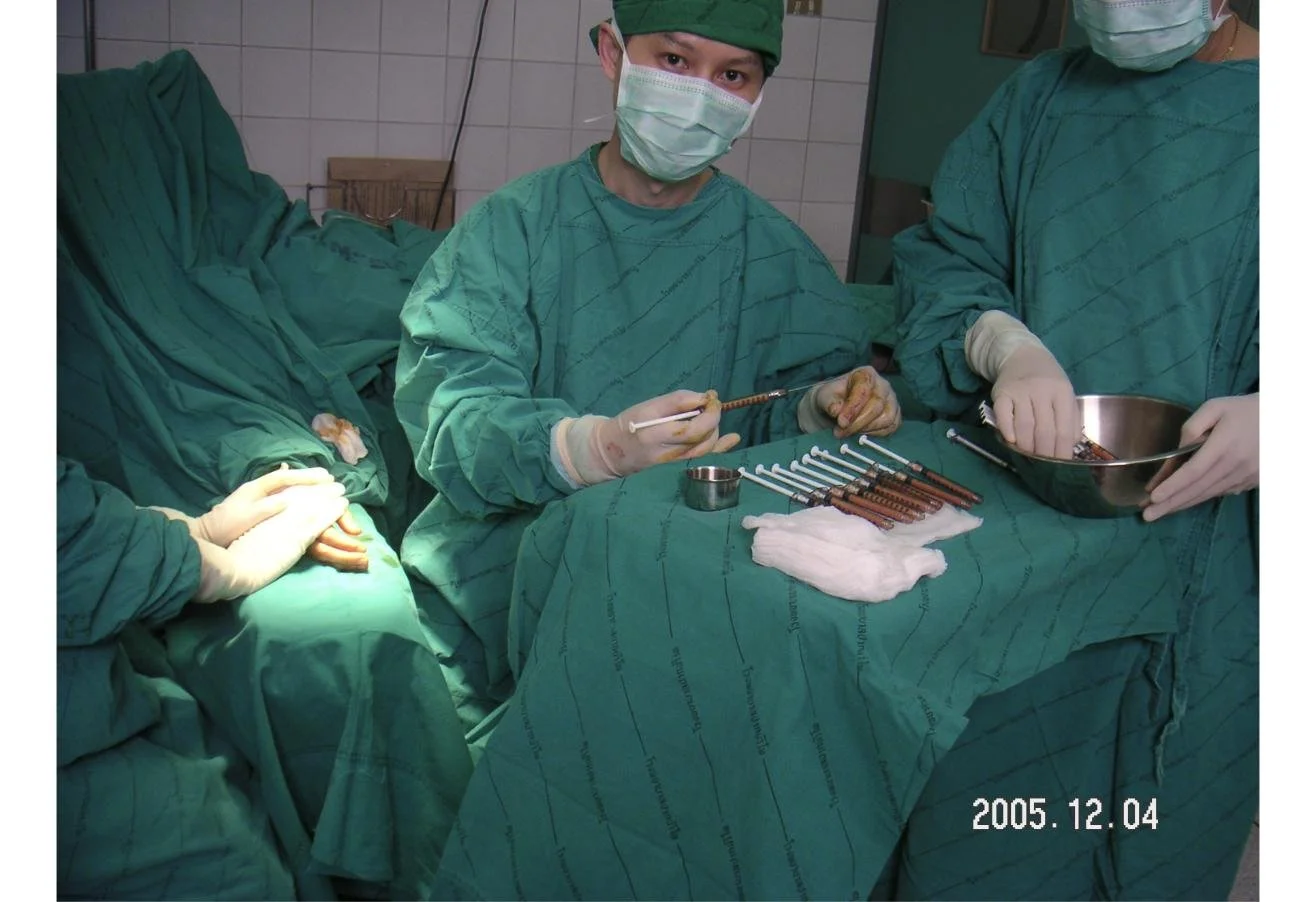 Dr. Rushapol Sdawat in green scrubs and mask in an operating theatre, December 2005
