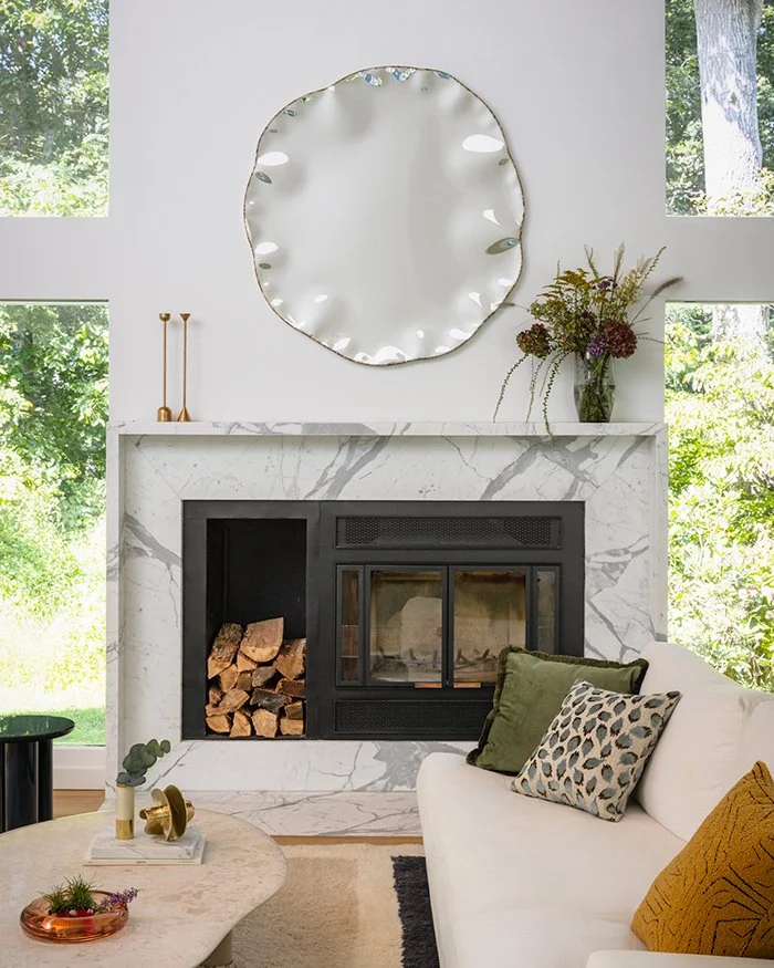 Modern living room, marble fireplace surround, statement mirror