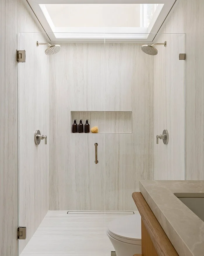 Modern walk-in shower, skylight, stone walls