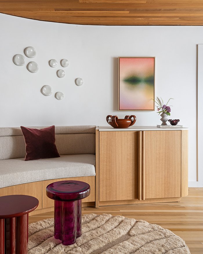 Modern living room, curved banquette, custom oak cabinetry