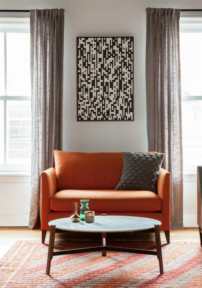 Jersey City Loft, sitting room with orange and gray artwork
