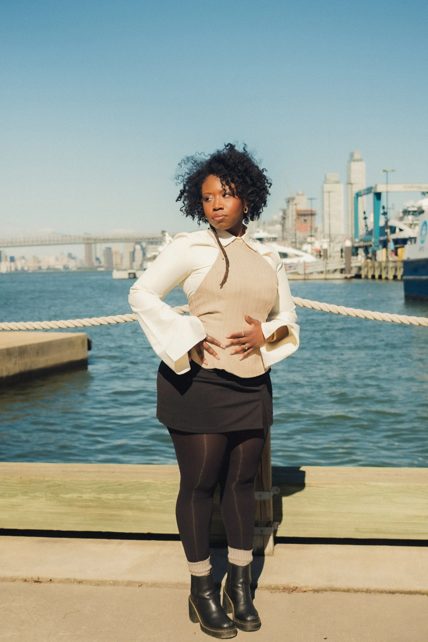 Jessica standing beside the waterfront and looking away