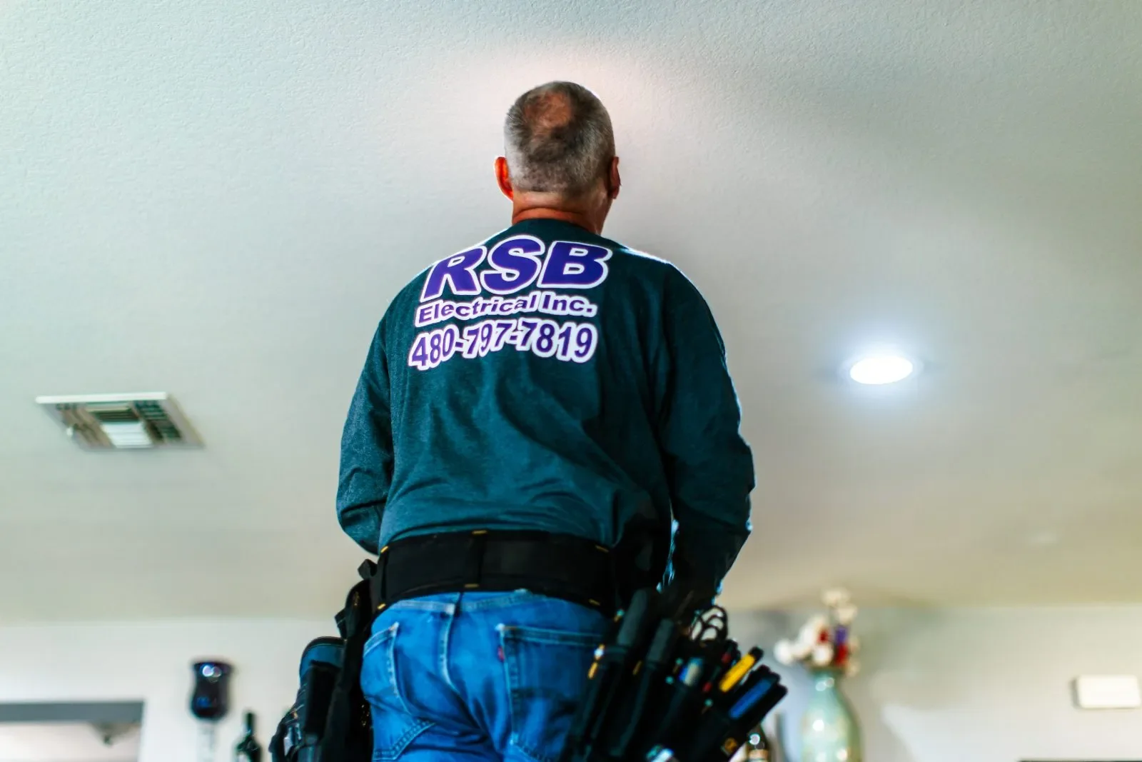 Electrician inspecting ceiling light — RSB Electrical, Mesa AZ