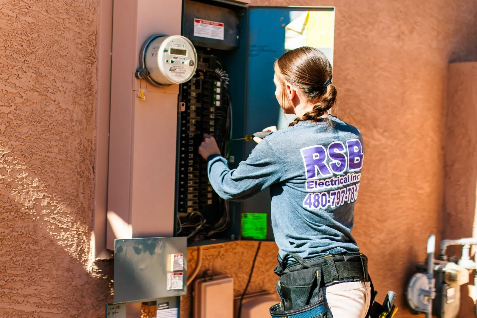 Electrician opening outdoor panel — RSB Electrical, Mesa AZ