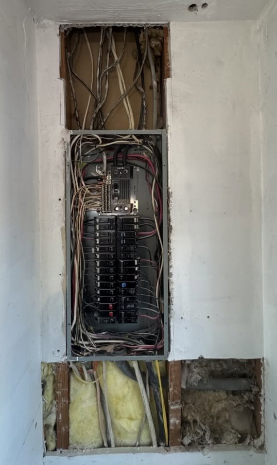 Panel in a wall opening with the wall finish cut back above and below it