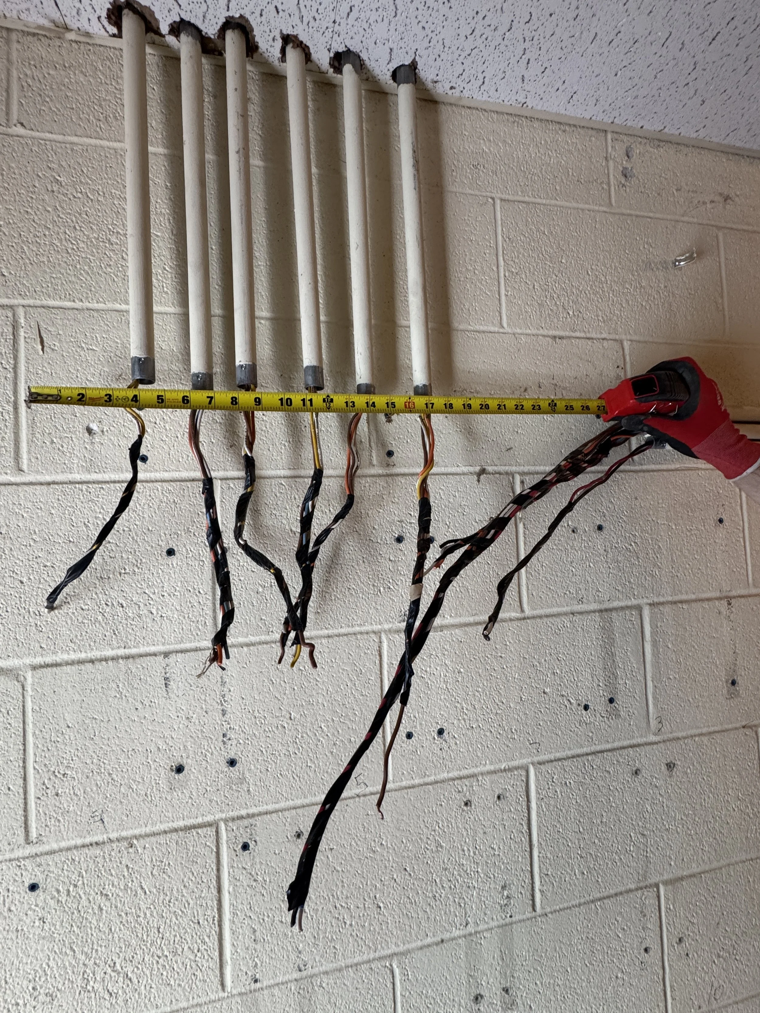Conductors stubbed out of a masonry wall along a rewired run