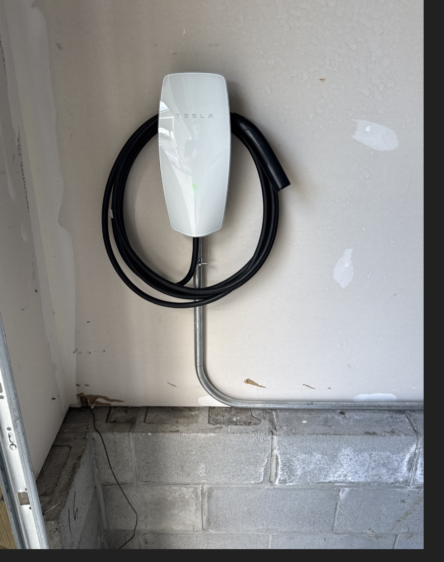 Charger mounted at the paved parking spot of a Portsmouth, VA home