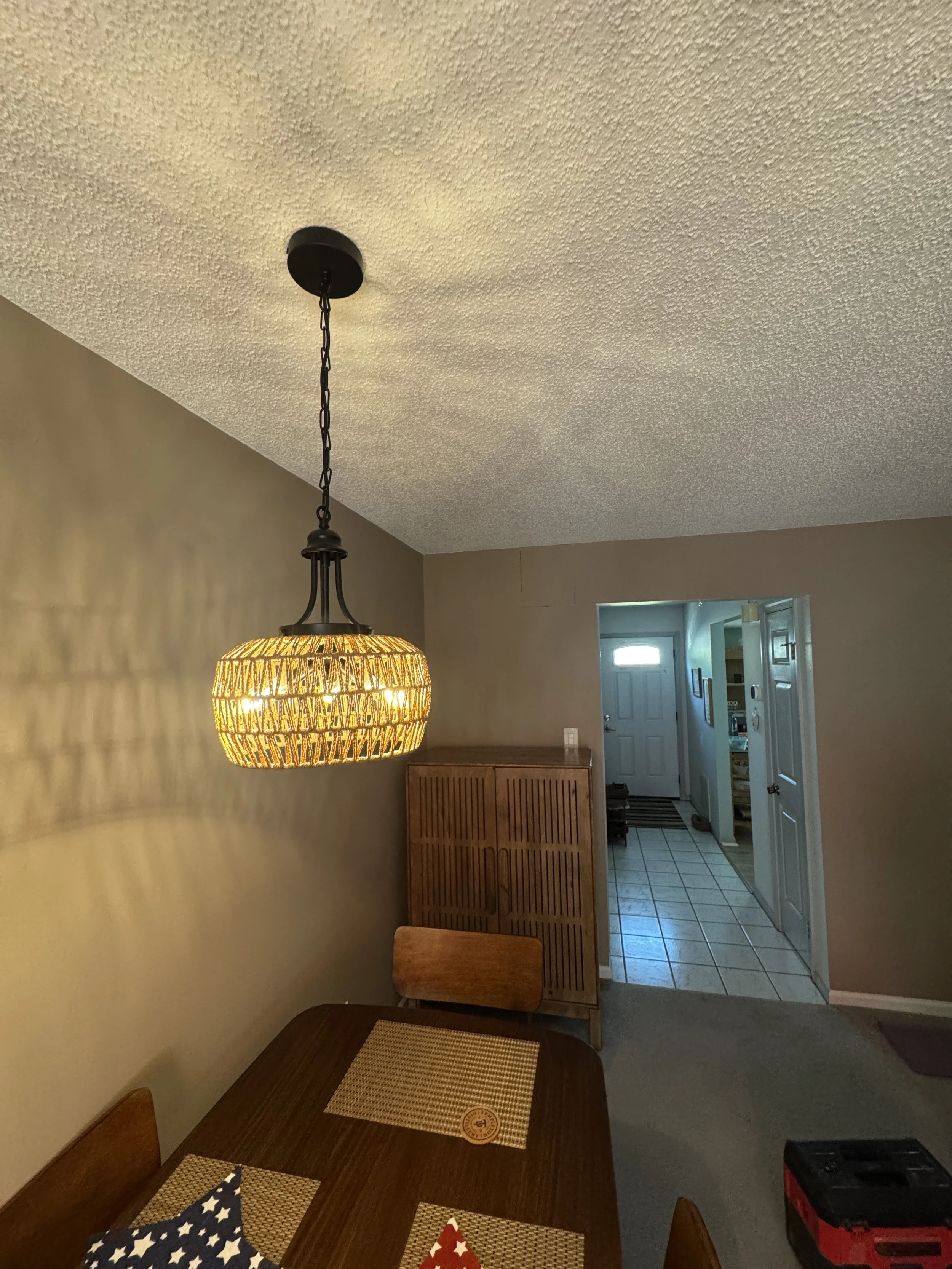 Pendant fixture lighting an entry hall