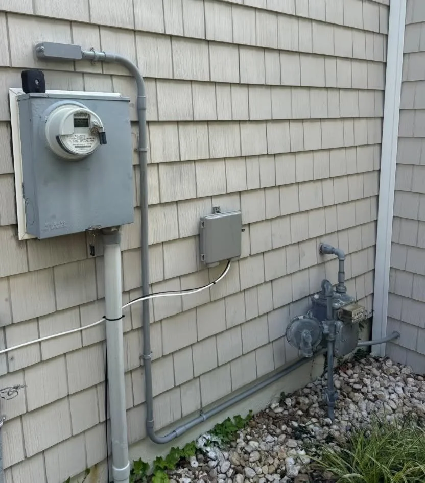 Meter and service conduit kept visible on the exterior wall of a Portsmouth, VA house