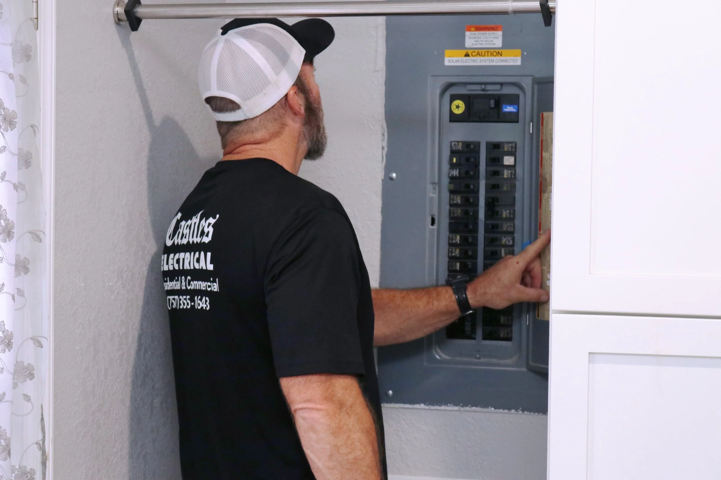 Castles Electrical electrician working at a panel in Norfolk, VA