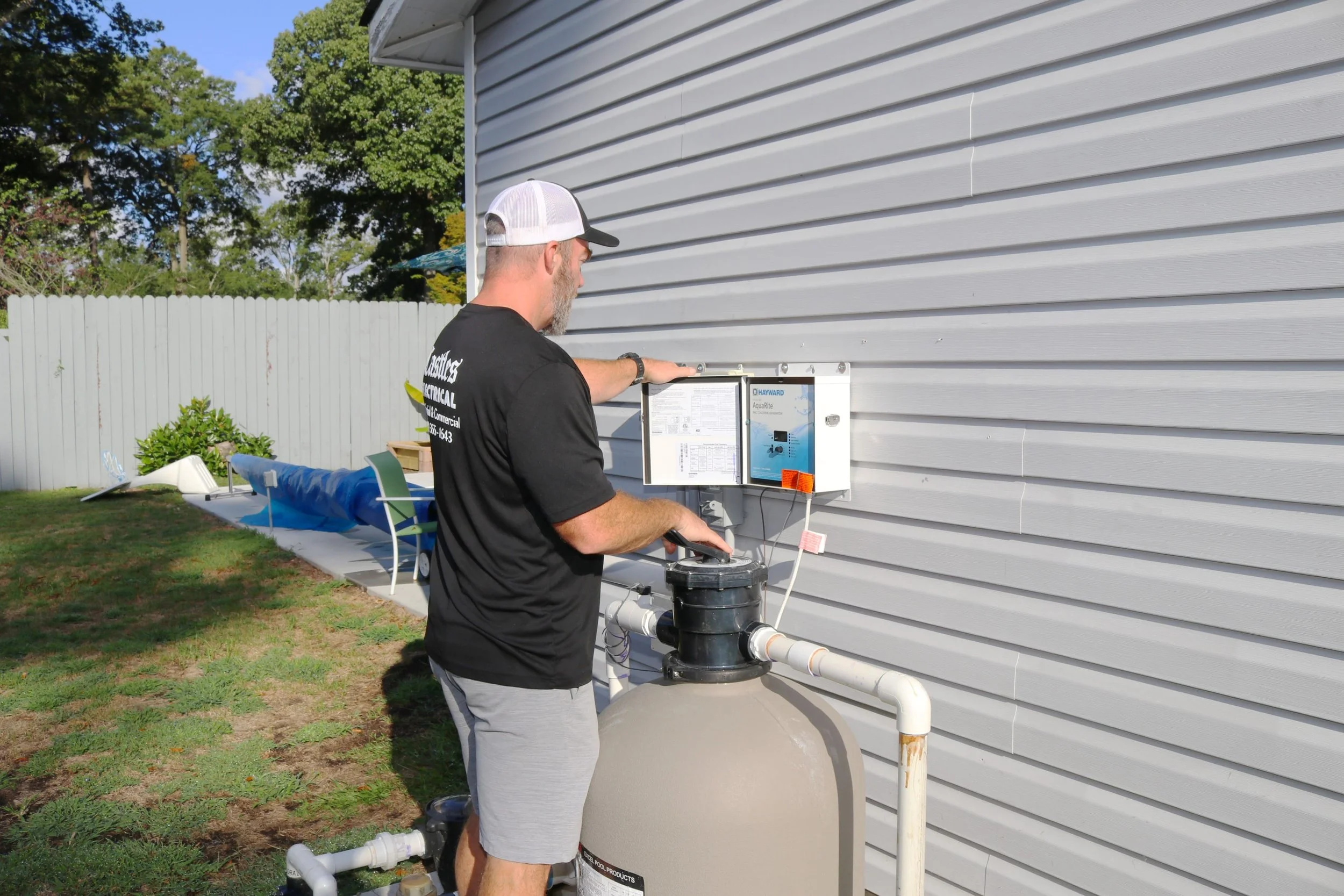 Castles Electrical electrician at the pool equipment controls of a Chesapeake, VA home