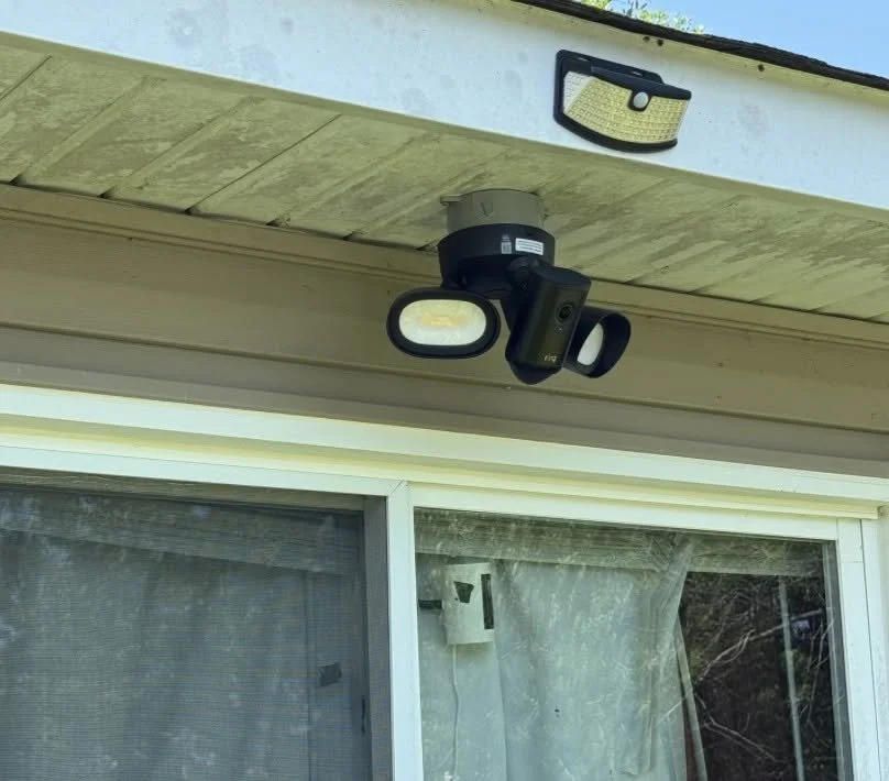 Shielded floodlight mounted under the eave of a Norfolk, VA home
