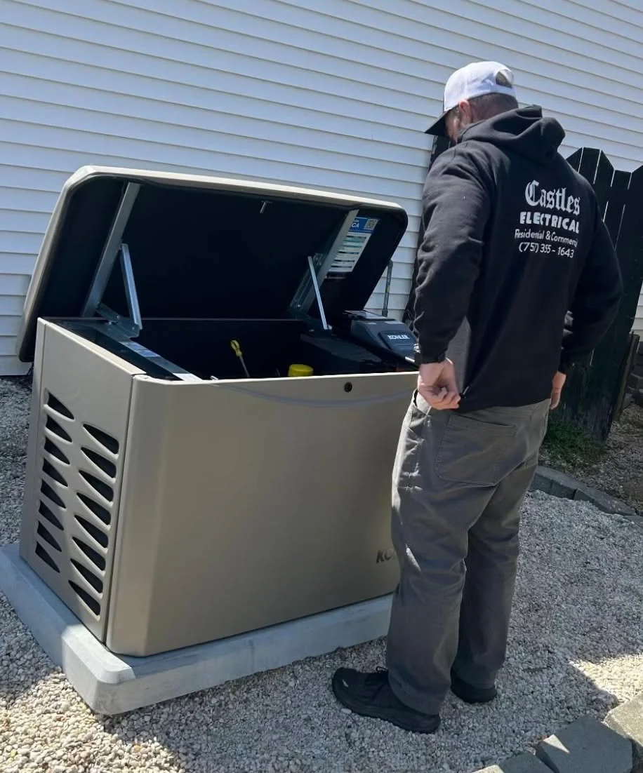 Castles Electrical electrician checking inside a standby generator in Norfolk, VA