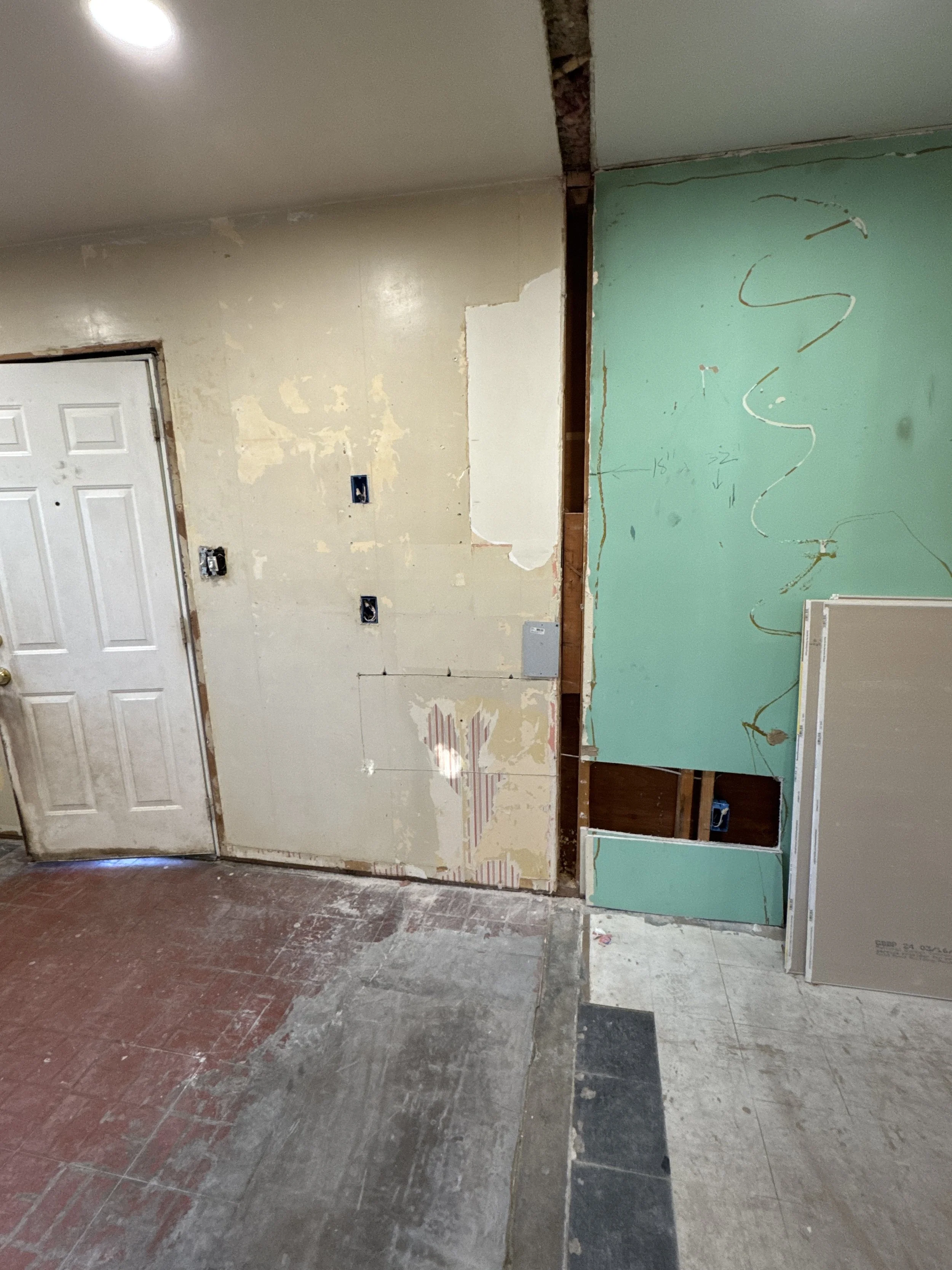 One section of wall opened beside a doorway in an older Portsmouth, VA house