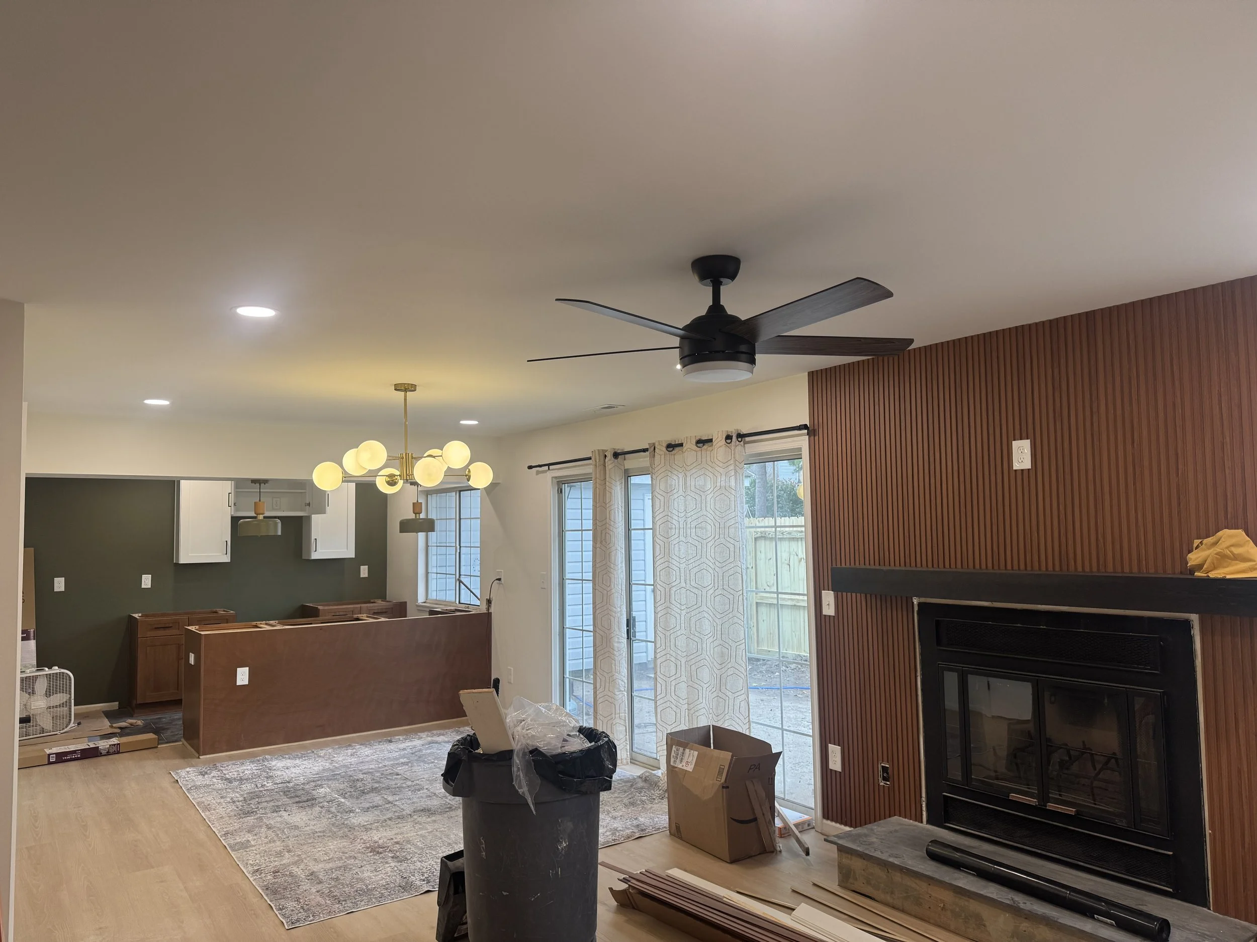 Recessed lights, a ceiling fan and a chandelier in a Chesapeake, VA living room