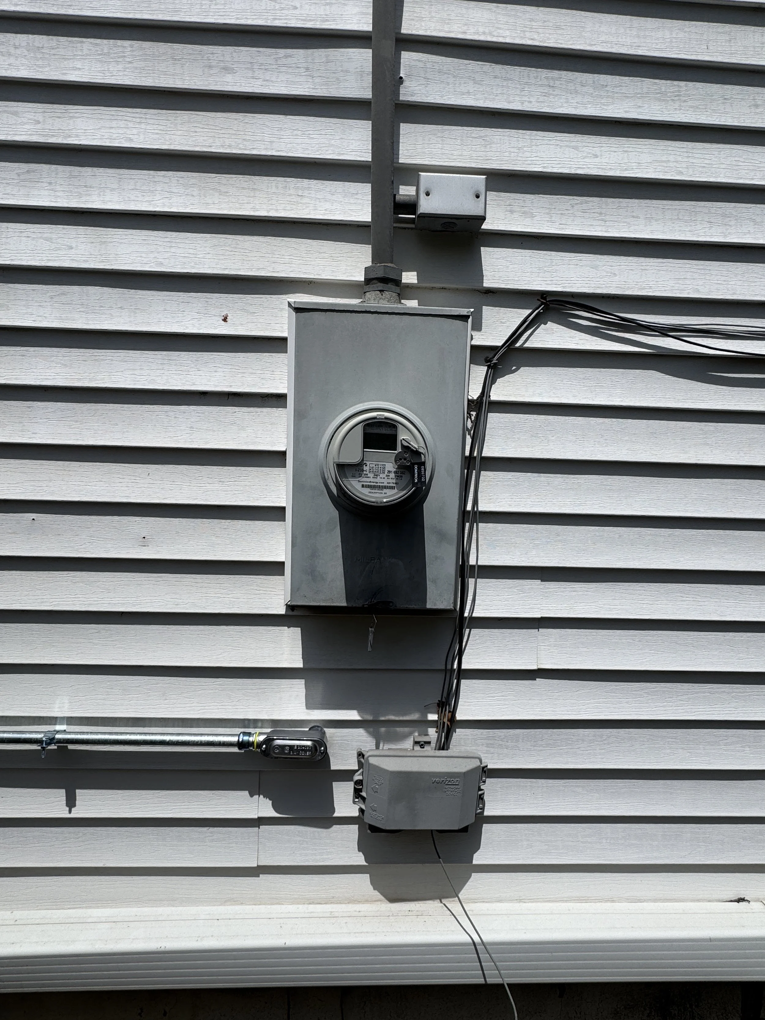 Service cable running down the wall to the meter on a Portsmouth, VA house